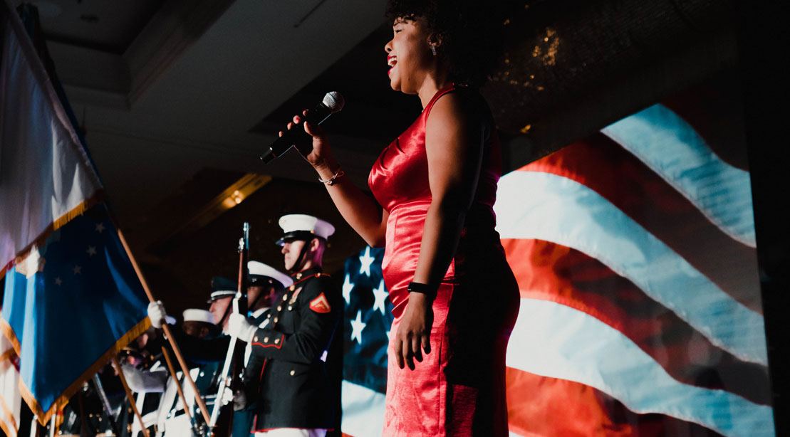 Singer singing for the 2022 NPC Armed Forces Nationals bodybuilding competition