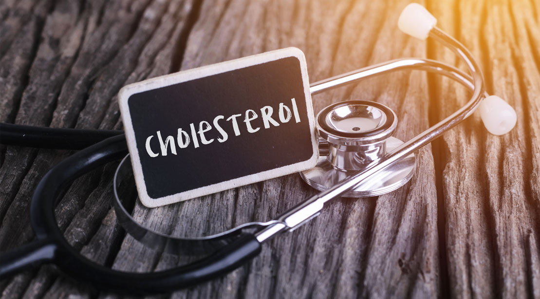 A stethoscope and cholesterol written on a chalk board
