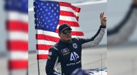 NASCAR driver Caesar Bacarella waves to fans on the tarmac