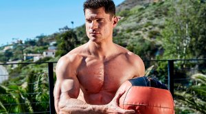Suicide squad actor Flula Borg holding and performing medicine ball exercises