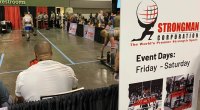 An enthusiast watching the strongman competition at the 2022 Olympia weekend expo