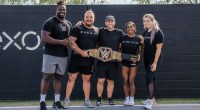 Five potential WWE wrestlers training under the the WWE NIL Program and holding the championship belt