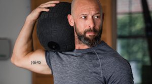 Greg Scheinman holding a medicine ball for a fitness workout that is consistent with his high performance lifestyle