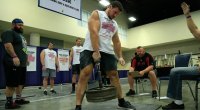 Strongman holding barbell plates
