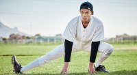 Baseball player performing a stretch recommended from head orthopedic surgeon for the New York Mets