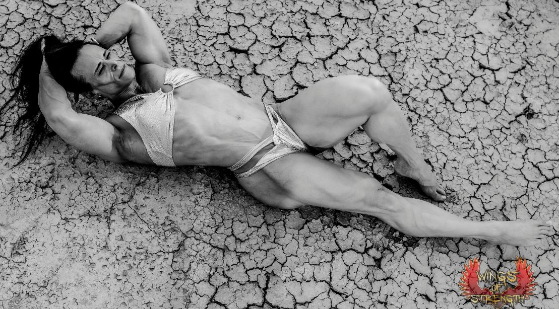 Donna Salib laying on the dried mud