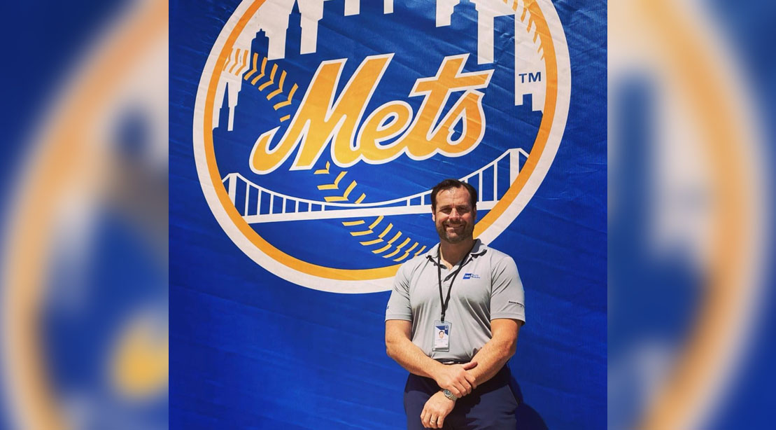Dr. Lawrence V. Gulotta, M.D. standing in front of a METs sign