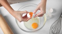 Female chef cracking an egg