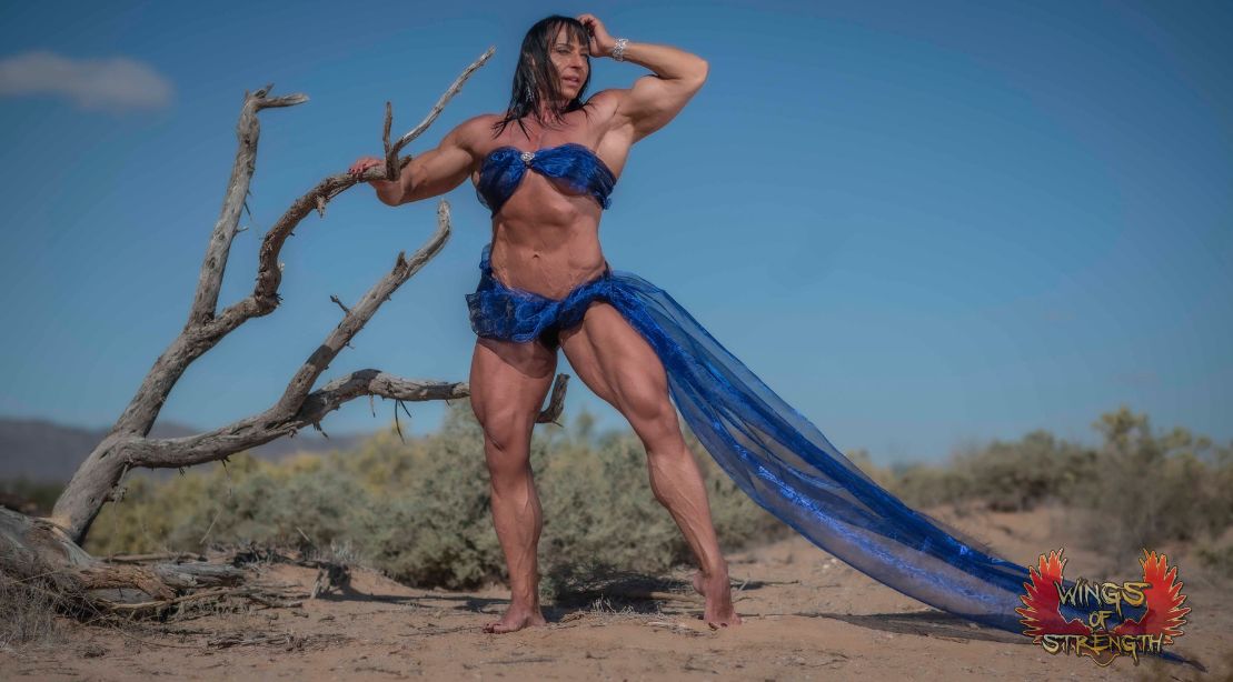 Irene Andersen posing in the desert wearing a blue bikini
