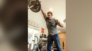 Scott Stallings performing a landmind press in the gym