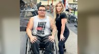Kirra Collins posing with an adaptive athlete in a wheelchair