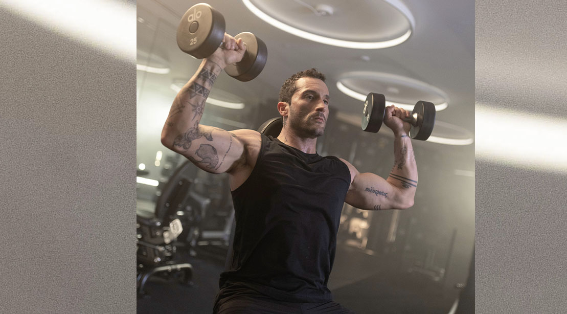 Gio Merlino performing a dumbbell press exercise for his upper body workout