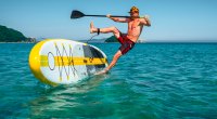 Man falling off a stand up paddleboard