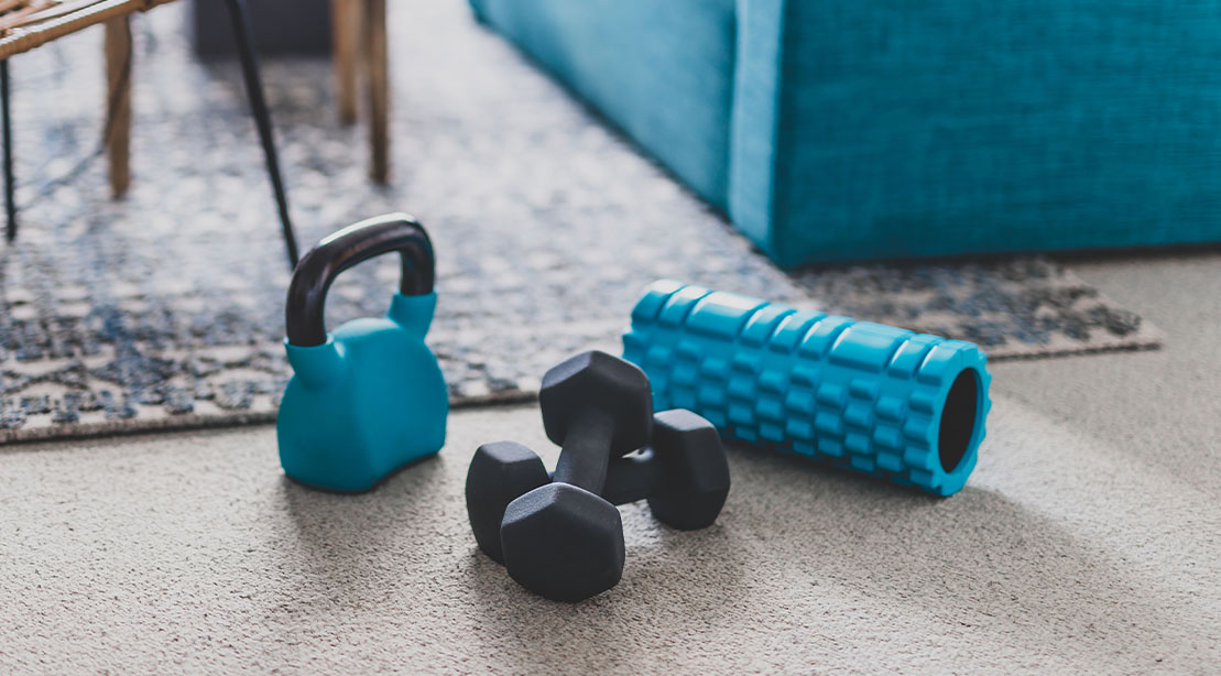 Gym equipment on the floor of a living room
