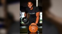 Jasper Bibbs performing a one handed pushup with a dumbbell and a basketball