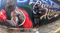 Boxer Richardson Hitching leaning on a street mural of him