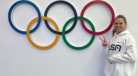 Kelly Curtis next to the olympic rings at the 2022 Winter Olympics in Beijing China