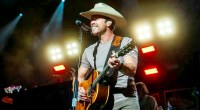 Country music star Dustin Lynch playing the guitar on stage