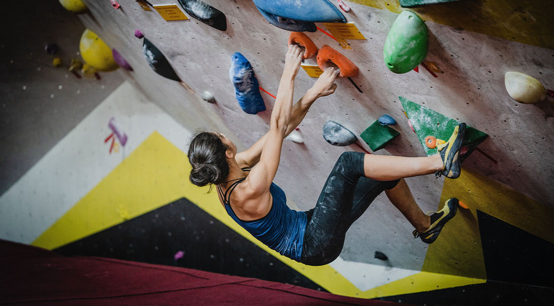 Fit man working out at an indoor rock climbing facility