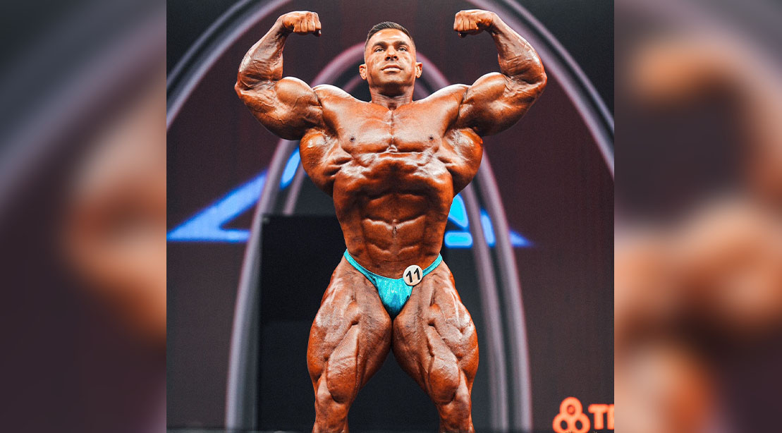 Bodybuilder Derek Lunsford flexing both of his biceps at the 2023 Olympia Fitness Competition
